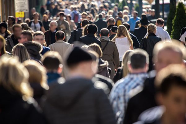 Crowd of potential clinical trial participants walking on a sidewalk
